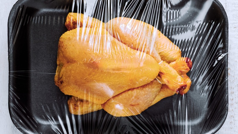 A raw whole yellow chicken