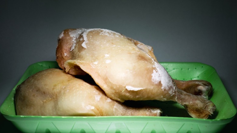 Dull raw chicken legs with freezer burn