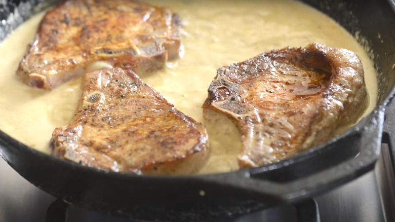 Pork chops cooking in milk