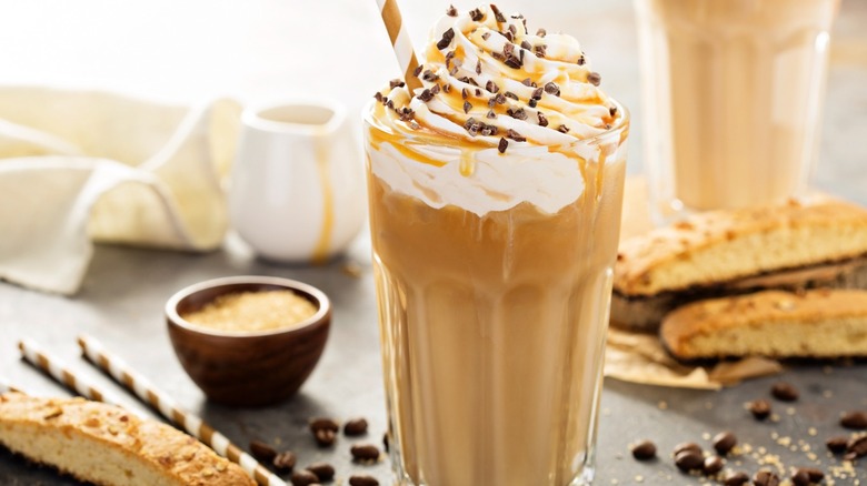 Caramel frappe or Frappuccino surrounded by biscotti