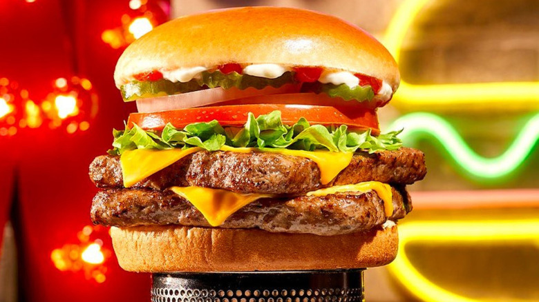 Wendy's Veggie Stack with two patties in front of a neon burger sign