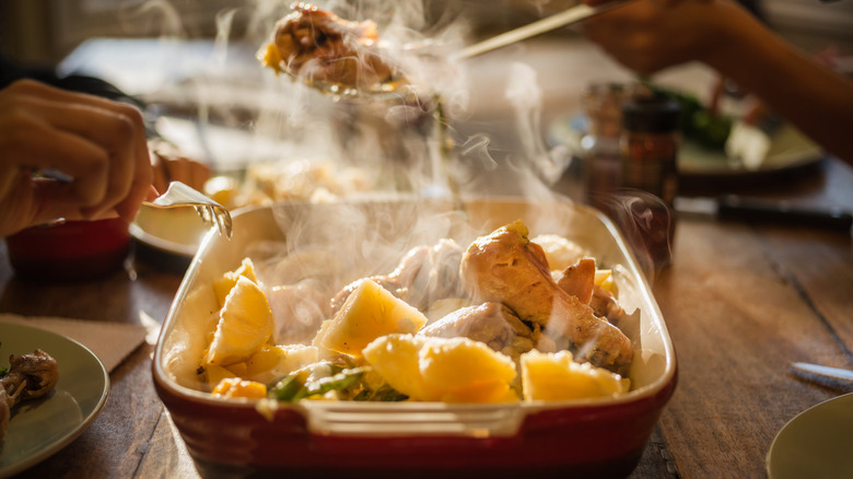 Steaming chicken at dinner table