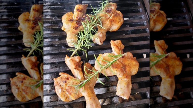 Butterflied chicken drumsticks on grill