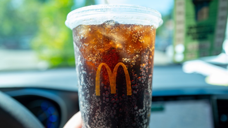 McDonald's Coke in a plastic to-go cup in a car