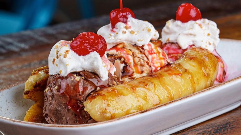 Banana split with whipped cream and cherries