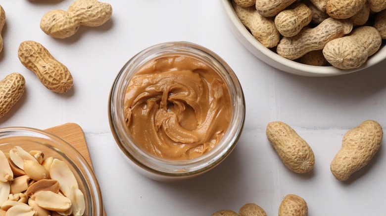 peanut butter jar and peanuts