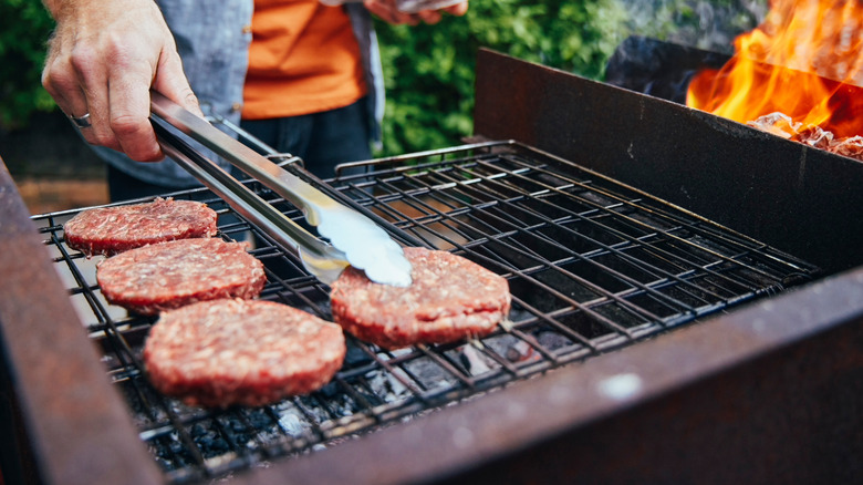 flipping burgers on grill