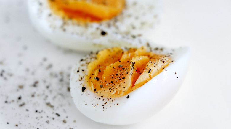 Sliced hard-boiled egg with pepper