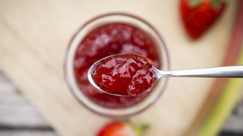 Spoonful of jelly over jar