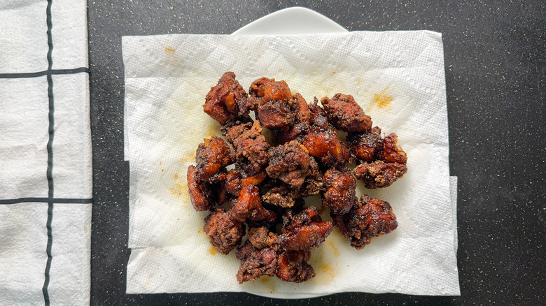 Chicken karaage resting on paper towel after frying