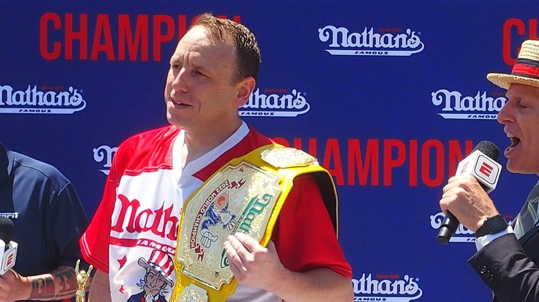 Joey Chestnut with Mustard Belt on his shoulder