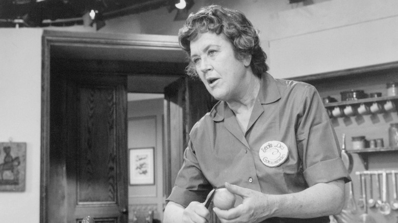 black and white photo of Julia Child in a kitchen