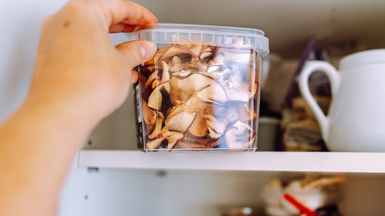 Dried apple chips being stored in the pantry