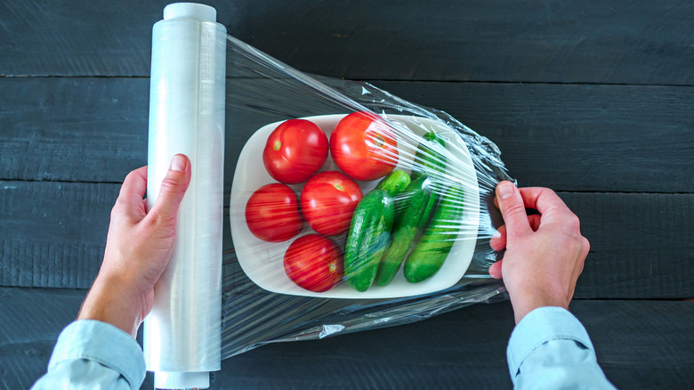 covering vegetables with plastic wrap