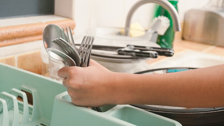 Grabbing silverware from drying rack