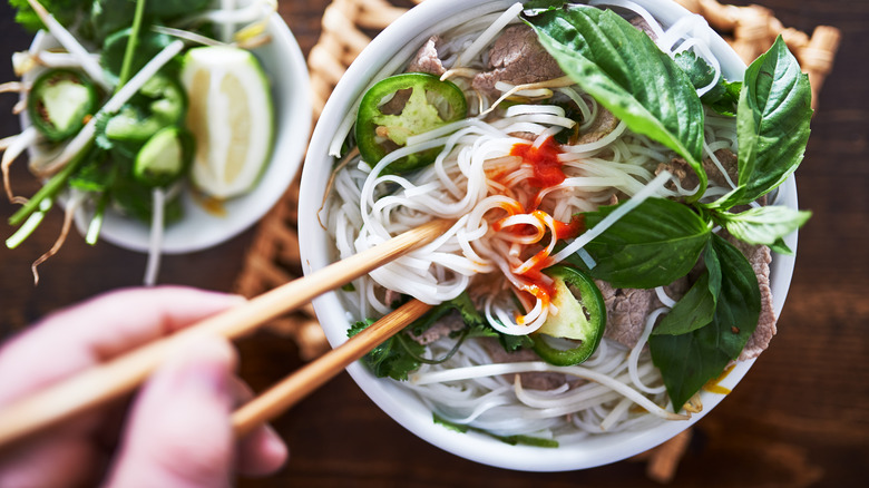 pho with plate of herbs