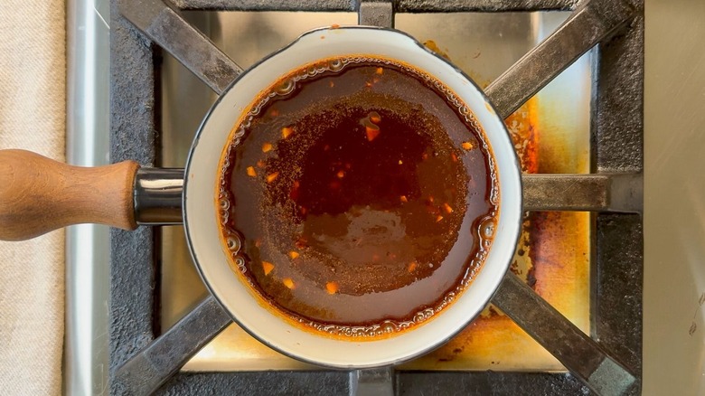 Cooking dipping sauce for Korean dry-rubbed wings in saucepan