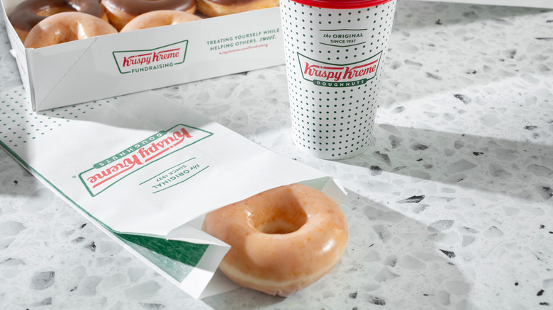 Krispy Kreme donuts and coffee sitting on a countertop