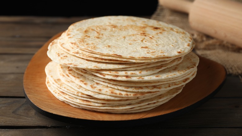 A stack of flour tortillas on a serving platter