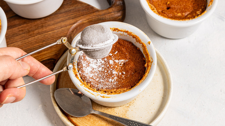 Dusting a carrot soufle with powdered sugar