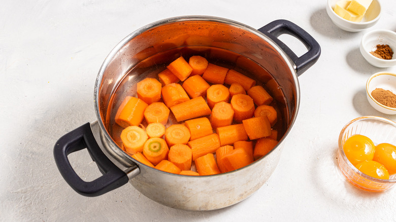 Pot with water and chopped carrots