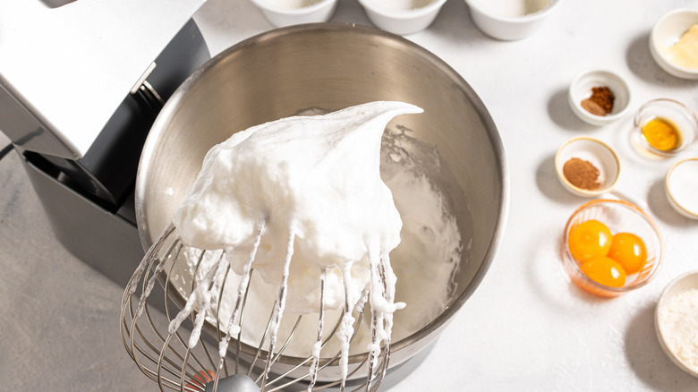 Stand mixer and a whisk with stiff peaks egg whites