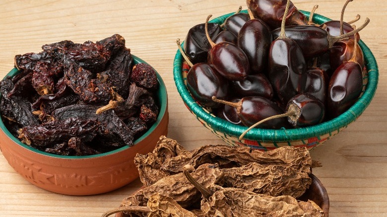 Ceramic bowls filled with various dark chiles