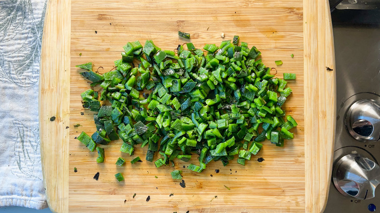 Chopped roasted poblano peppers on cutting board