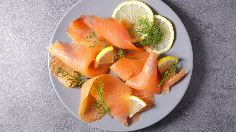 Smoked salmon with herbs and lemon slices