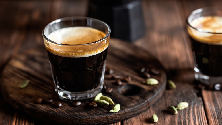 Espresso shot with cardamom seeds and coffee beans