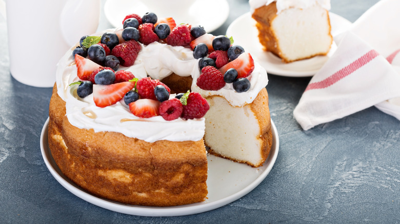 Angel food cake topped with whipped cream and berries