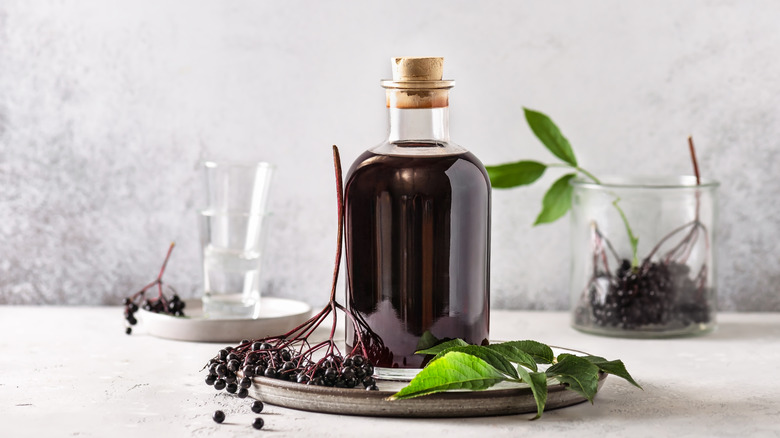 bottled homemade syrup with berries on the side