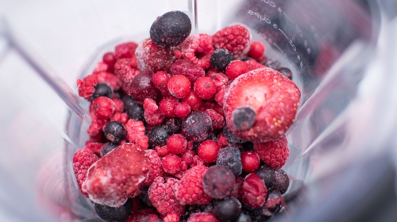 Closeup of frozen berries in a blender