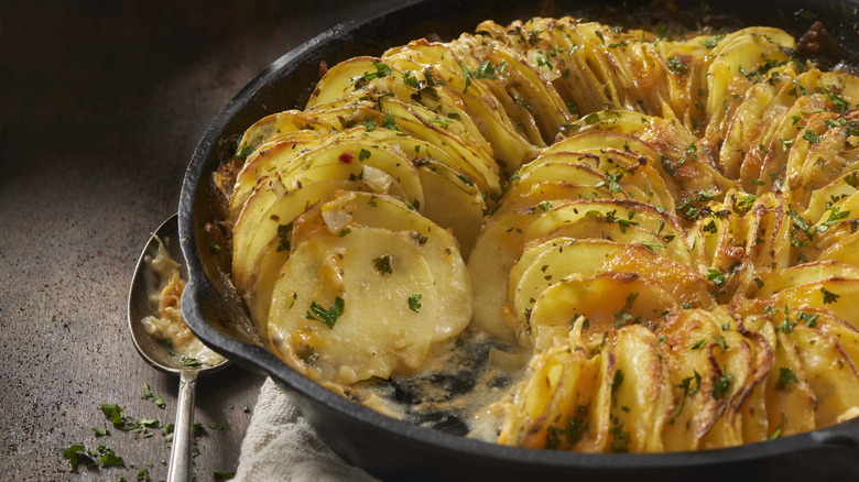 Cast iron pan of cheesy au gratin potatoes