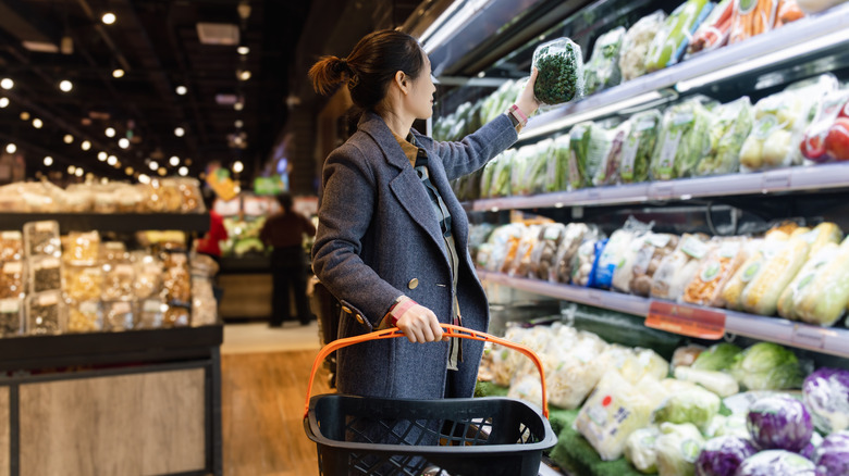 Woman holding produce at the grocery store