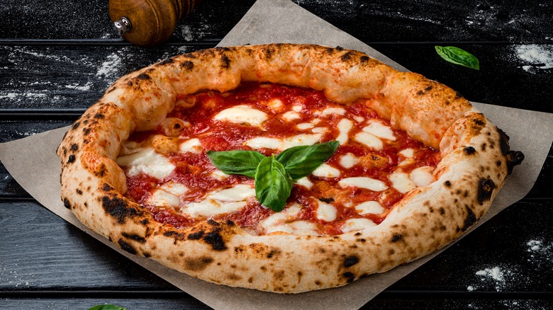 Margherita pizza on dark background