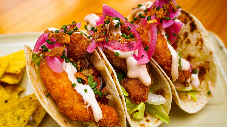 Trio of fish tacos with pickled onions