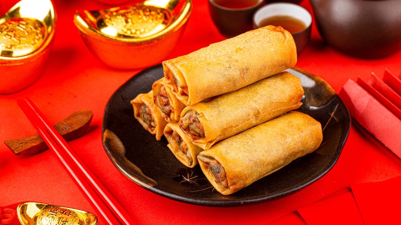 Spring rolls stacked on plate
