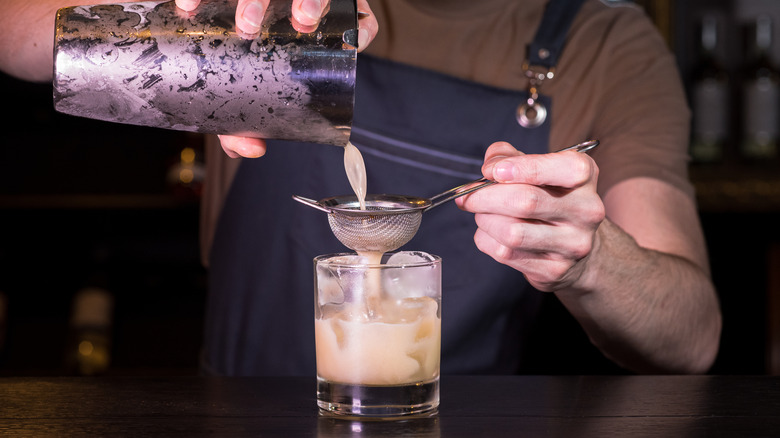 Bartender making a whiskey sour 