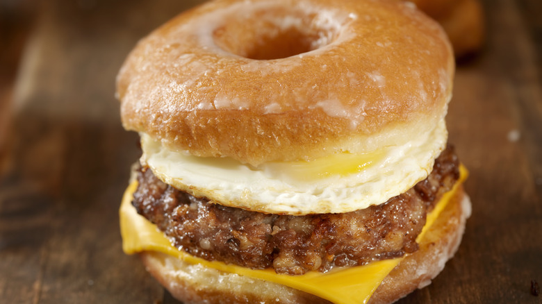 A breakfast sandwich made with a glazed donut