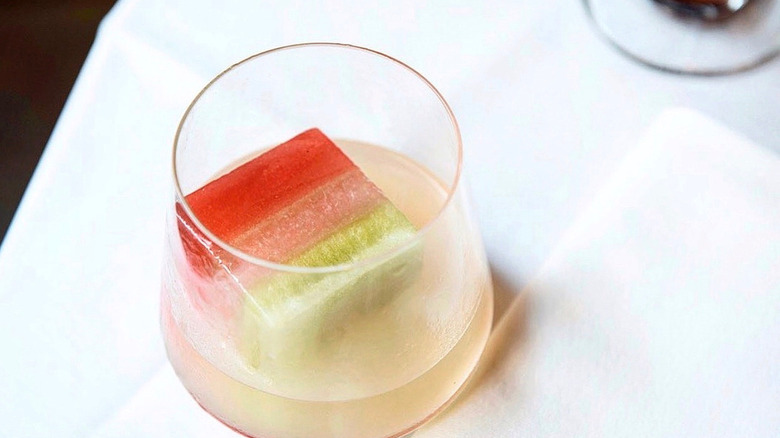 Tricolor Italian flag ice cubes in margarita on table.