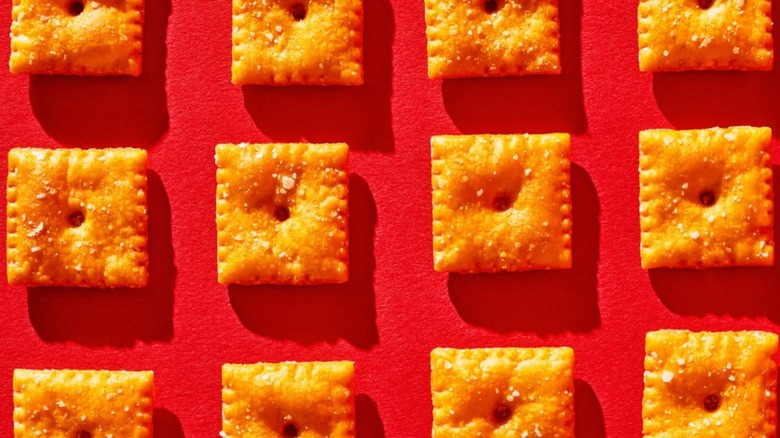 Rows of Cheez-Its on a red background