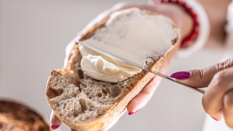 spreading butter on bread with butter knife