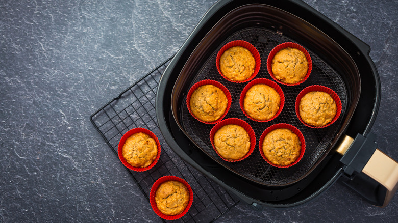 brown muffins in red muffin cups sitting in black airfryer basket