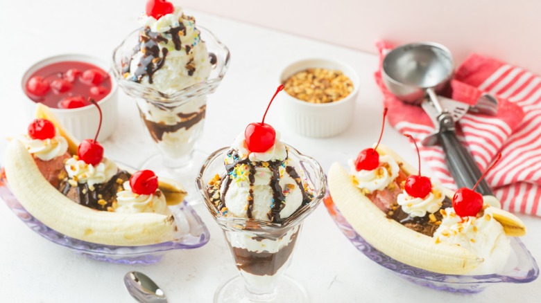 Various ice cream desserts topped with maraschino cherries