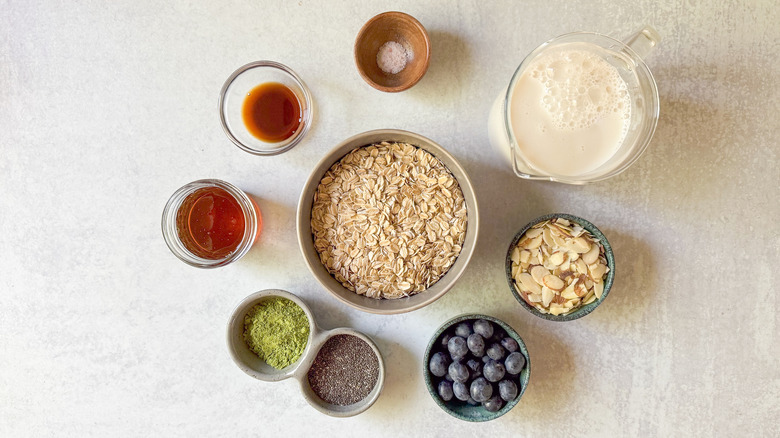 Matcha almond overnight oats ingredients on countertop