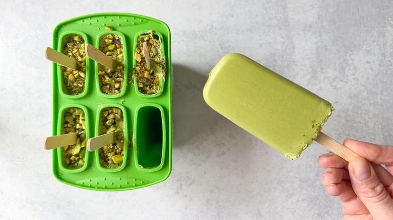 Removing matcha pistachio popsicles from molds