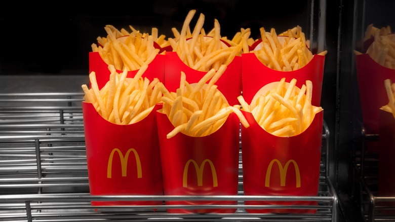 Boxes of McDonald's fries on a restaurant kitchen shelf