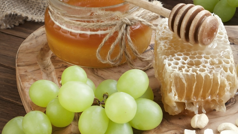 honey and grapes on a table