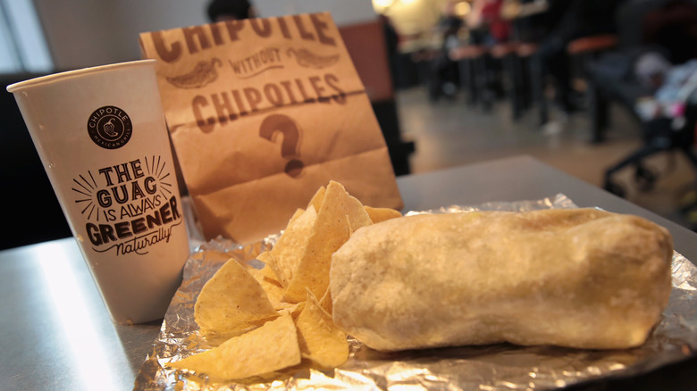 Chipotle burrito with chips and drink